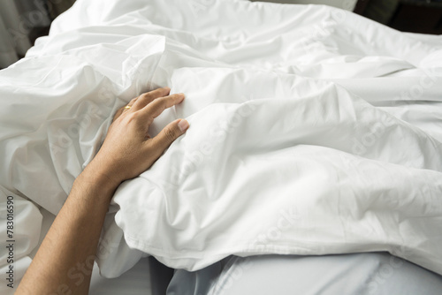 Close up hand holding blanket on bedroom.Wake up on the morning time.