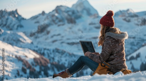 Woman working on laptop in snowy mountains © Lubos Chlubny