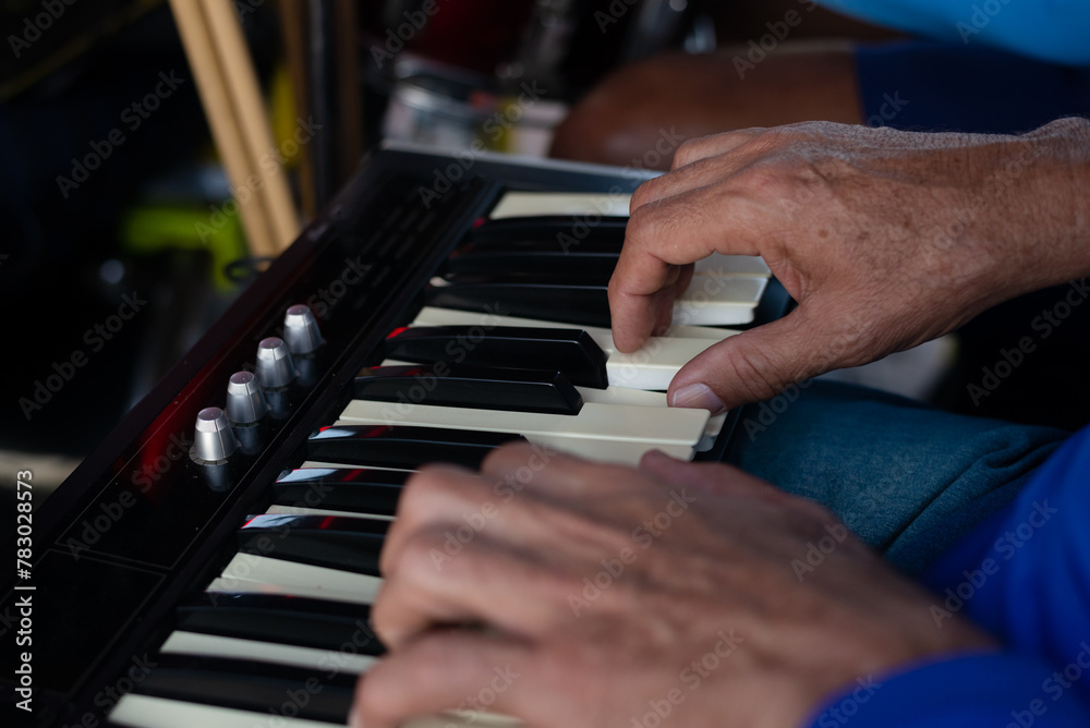 Obraz premium Detail of a hand playing the keyboard at an event.