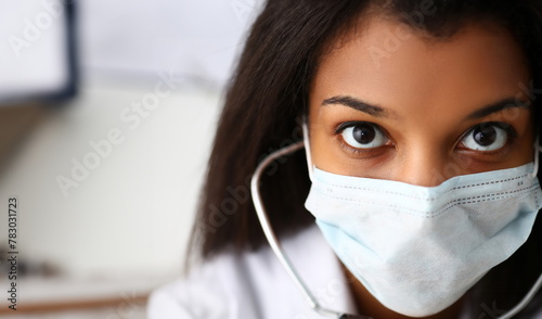 Black female doctor in a face mask. Physical and disease prevention, patient aid exam visit 911 ward round prescribe remedy healthy lifestyle consultant profession concept