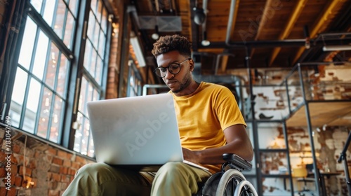 Man in Wheelchair Using Laptop photo