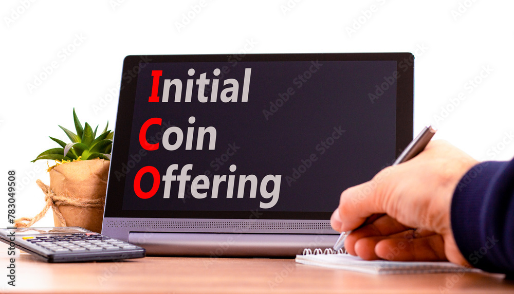 ICO initial coin offering symbol. Concept words ICO initial coin offering on beautiful black tablet. Beautiful white background. Businessman hand. Business ICO initial coin offering concept Copy space