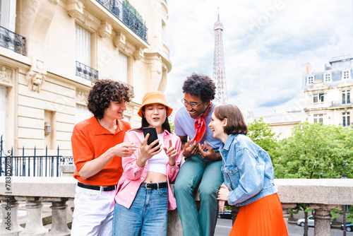 Multiethnic group of young happy friends visiting Paris and Eiffel Tower © oneinchpunch