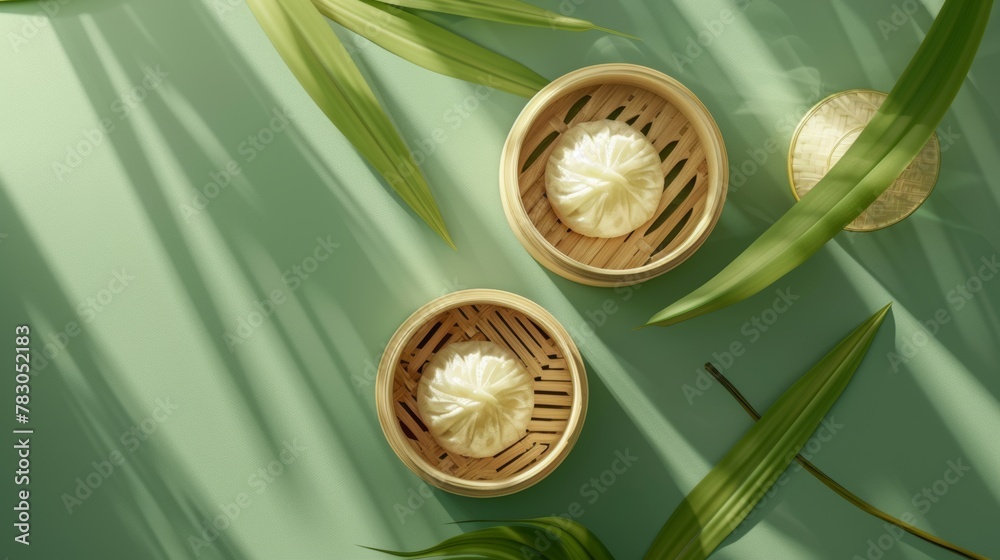 Chinese sticky rice dumplings viewed from above, one on a steamer and the other on a bamboo leaf. Duanwu Festival elements isolated on green background. Chinese sticky rice dumplings viewed from above, one on a steamer and the other on a bamboo leaf. Duanwu Festival elements isolated on green background.