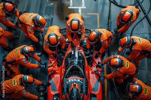 Professional pit crew ready for action as their team's race car arrives in the pit lane during a pitstop of a car race