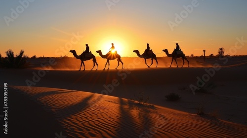 In the fading light of sunset, camels and their riders weave through the desert, their silhouettes casting long shadows on the sand.