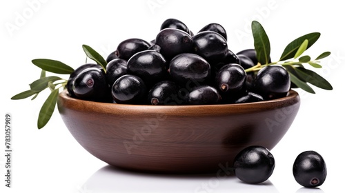 Black olives in wooden bowl with leaves isolated on white background cutout