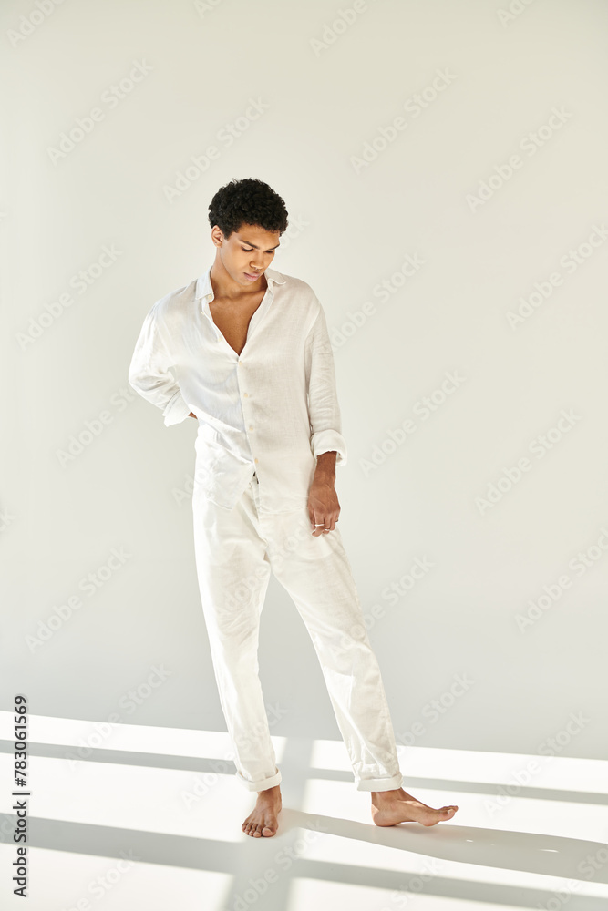 appealing elegant african american man in chic linen clothing looking away on beige backdrop appealing elegant african american man in chic linen clothing looking away on beige backdrop