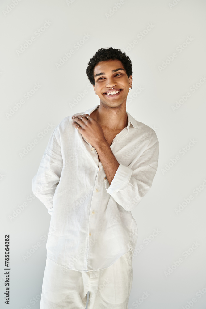 contented alluring african american male model in white linen attire looking away on beige backdrop contented alluring african american male model in white linen attire looking away on beige backdrop