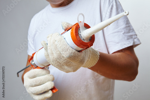 woman's hand holding a pencil with glue