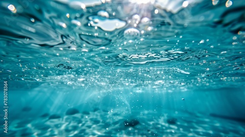 Underwater photograph of an olympic pool, capturing the submersion in the aquatic depths