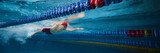 Young concentrated man, swimming athlete in motion in swimming pool training, preparing for upcoming competition. Concept of professional sport, health, endurance, strength, active lifestyle. Banner