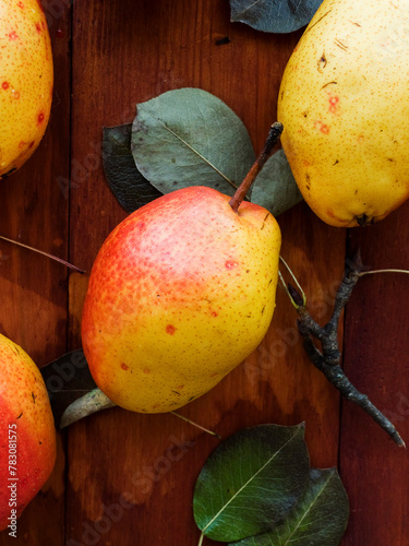 Fresh ripe pears laying on the wooden background. Top view.