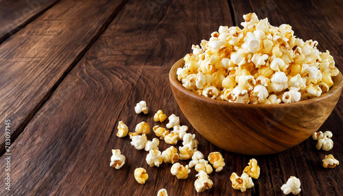 Close-up of an olive wood bowl full of tasty popcorn on a brown old wooden table with copy space. Generative Ai.