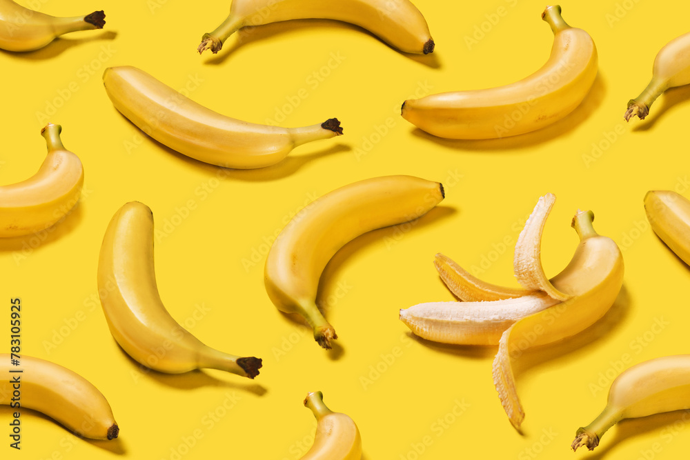 Banner bananas with hard shadows creative pattern on yellow background flat lay