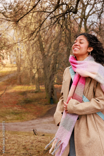 Model shoot in a park of a charming curly-haired Latina girl with a cute face