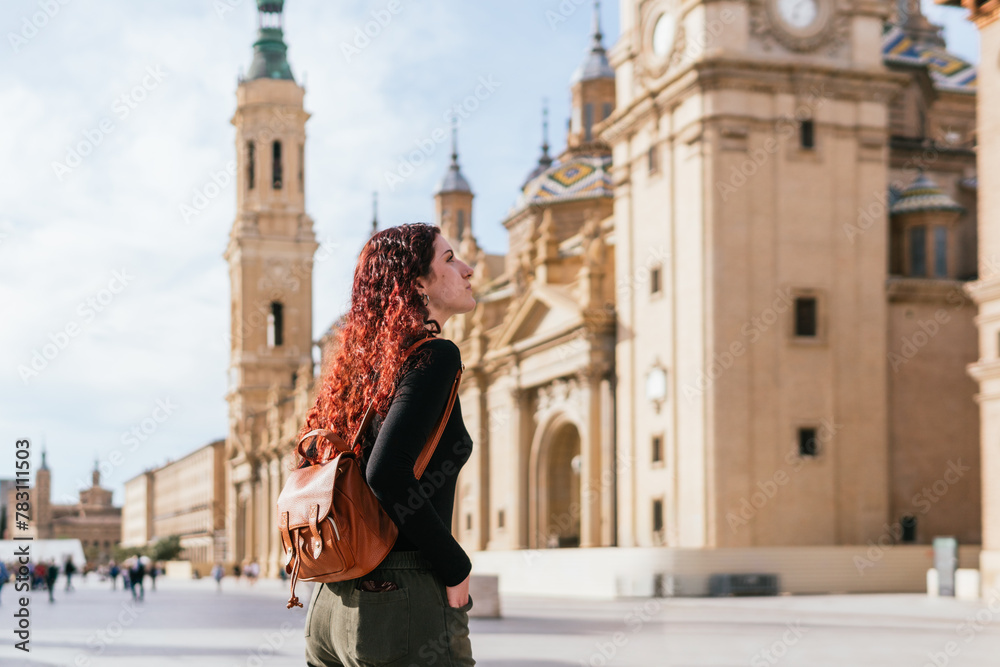 Fototapeta premium Traveler observing the Basilica del Pilar in the city center of Zaragoza, Spain