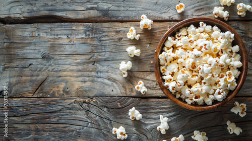 Popcorn in the bowl on old wooden background