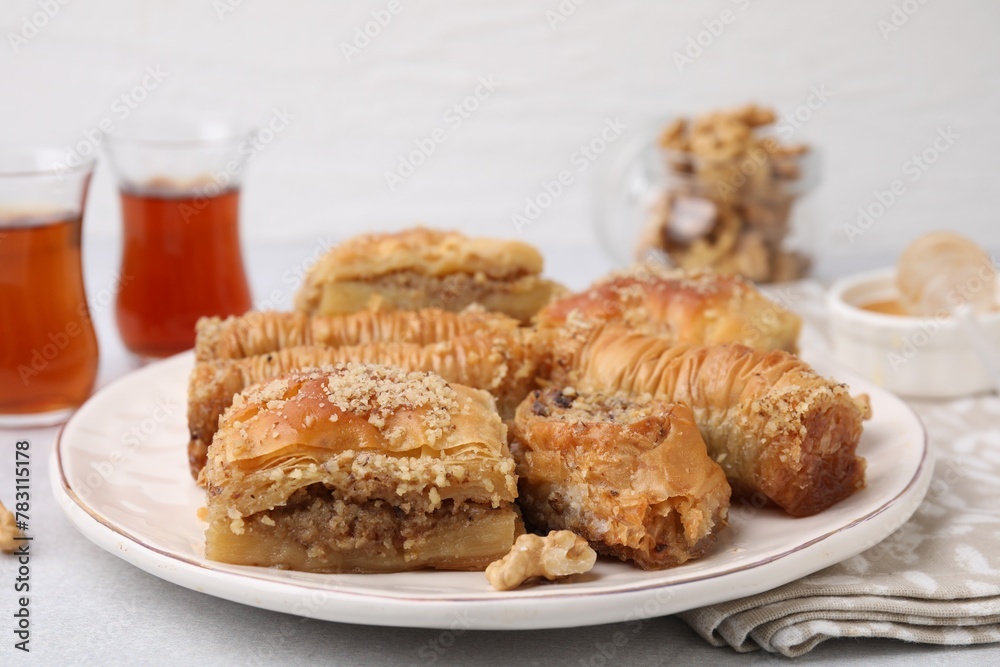 Eastern sweets. Pieces of tasty baklava on white table, closeup Eastern sweets. Pieces of tasty baklava on white table, closeup