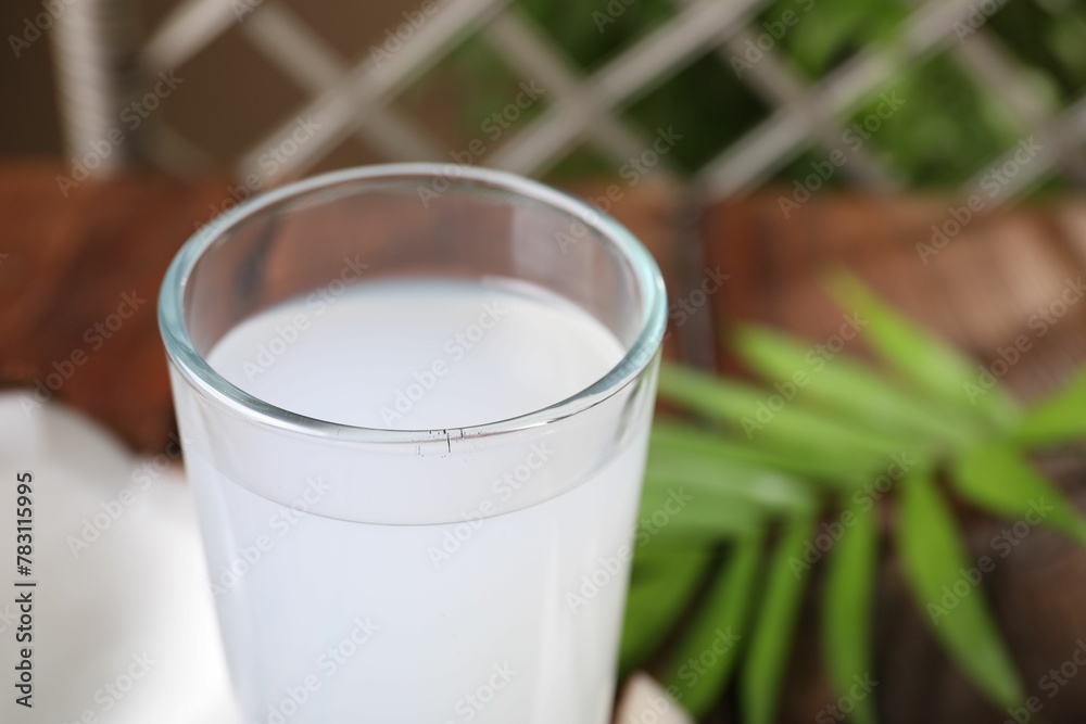 Glass of coconut water on table, closeup Glass of coconut water on table, closeup