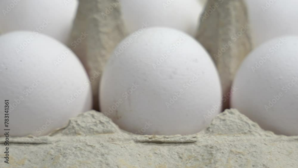 Packs of white chicken eggs. White chicken eggs in a package close-up. Packs of white chicken eggs. White chicken eggs in a package close-up.