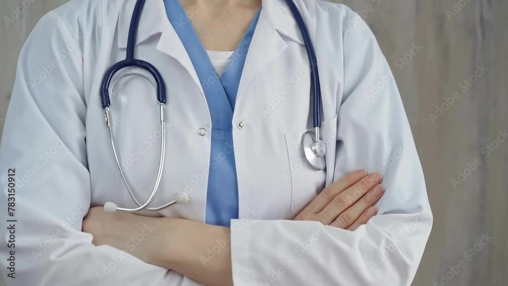 Confident healthcare professional with stethoscope. Close-up of a medical doctor in white coat with folded arms. Medicine concept