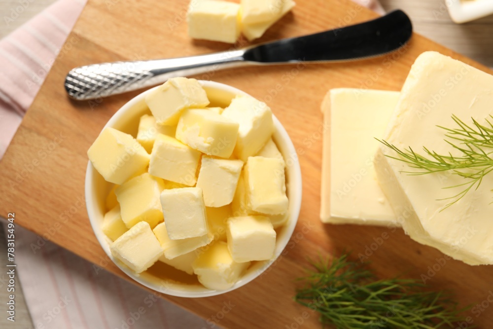 Tasty butter with dill and knife on wooden table, top view Tasty butter with dill and knife on wooden table, top view