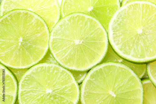 Fresh juicy lime slices as background, top view