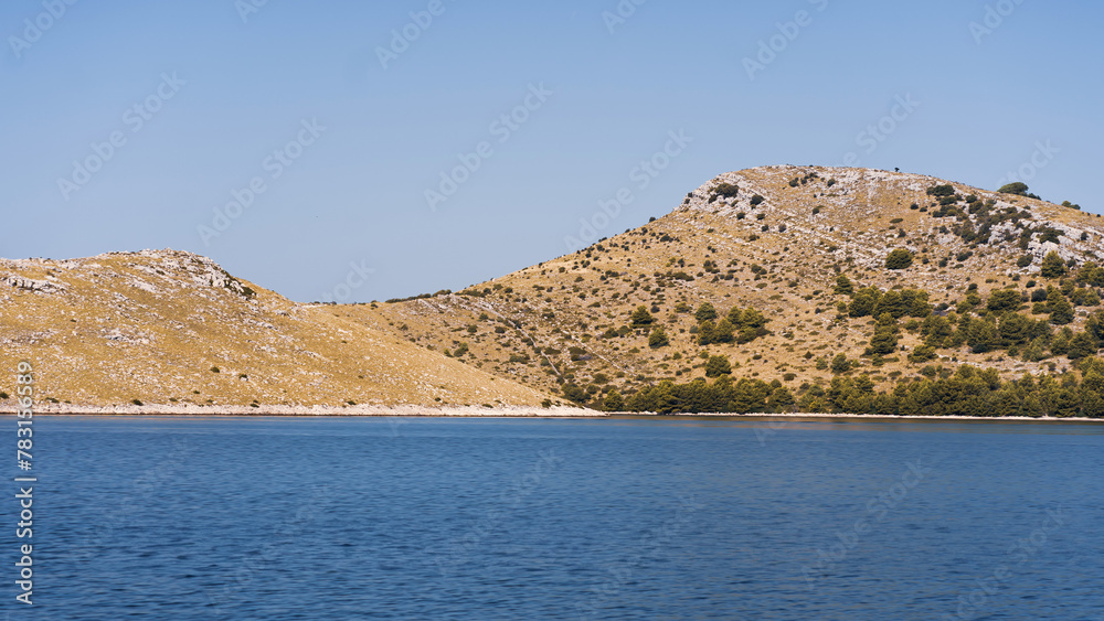 Scenic landscape with rocks, pines and hills on seashore, Dugi Otok island in Adriatic Sea, Croatia