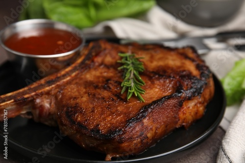 Tasty grilled meat, rosemary and marinade on table, closeup