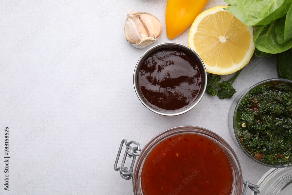 Different marinades and products on light table, flat lay. Space for text Different marinades and products on light table, flat lay. Space for text