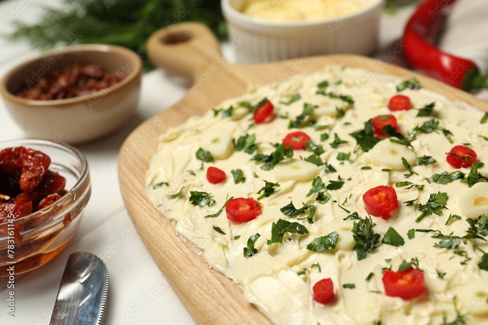 Fresh natural butter board with pepper and parsley on white table, closeup