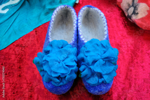 Traditional Kyrgyz slippers, woman shoes made of felt placed on a table
