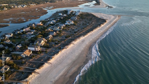 South Carolina coastline at Pawleys Island beach front homes, vacation beach rental property beside ocean with sandy shoreline at sunrise on beautiful morning by the sea