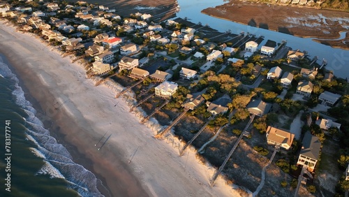 South Carolina coastline at Pawleys Island beach front homes, vacation beach rental property beside ocean with sandy shoreline at sunrise on beautiful morning by the sea