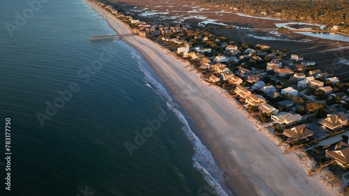 South Carolina coastline at Pawleys Island beach front homes, vacation beach rental property beside ocean with sandy shoreline at sunrise on beautiful morning by the sea