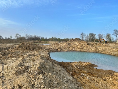 quarry, excavation of earth, water in excavations, excavators, mountains of earth and sand