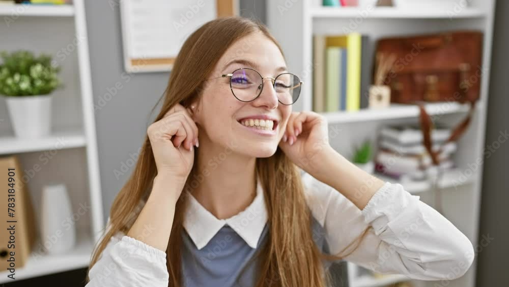 Comical audition mishap in office setting, young blonde business woman playfully pulling ears, flashing funny expression and infectiously cheerful smile. Comical audition mishap in office setting, young blonde business woman playfully pulling ears, flashing funny expression and infectiously cheerful smile.