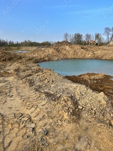 quarry, excavation of earth, water in excavations, excavators, mountains of earth and sand