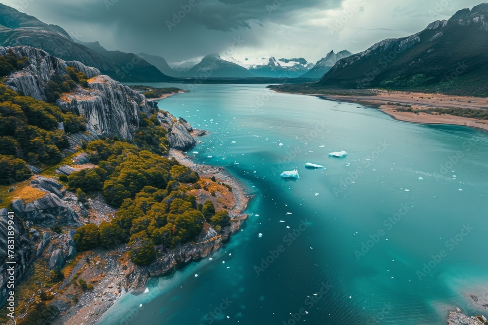 A stunning aerial view of a lake nestled among towering mountains and lush trees