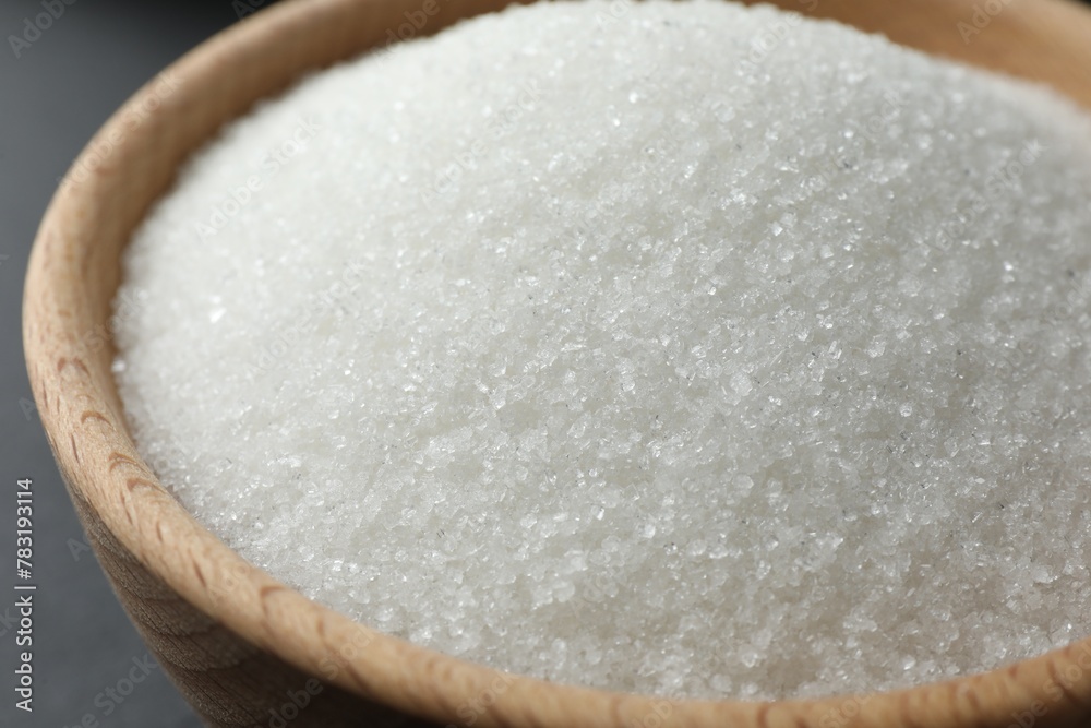 Granulated sugar in bowl on table, closeup Granulated sugar in bowl on table, closeup