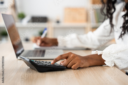 Closeup of hand using calculator. Small business finance concept.