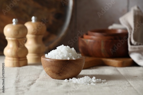 Organic salt in wooden bowl on table