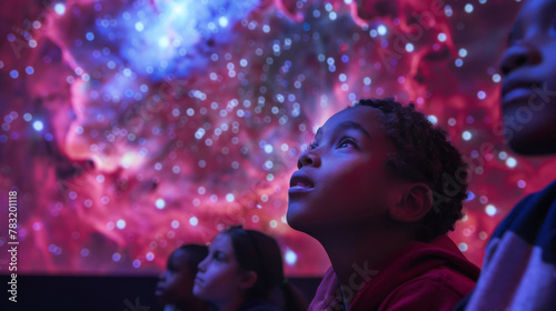 Children Mesmerized by Cosmic Light Display in Planetarium photo