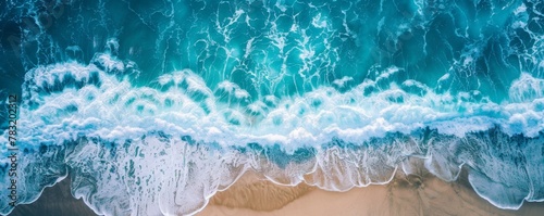 Water waves crashing on sandy beach, creating mesmerizing patterns