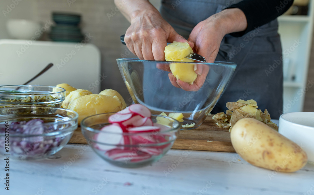 Making potato salad. Woman cutting fresh cooked potatoes Making potato salad. Woman cutting fresh cooked potatoes