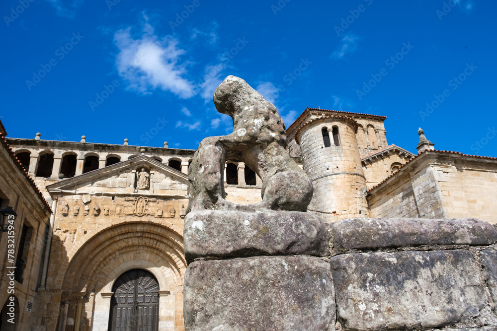 A statue of a gorilla seated atop a sturdy stone wall in Santillana del Mar, Cantabria. The gorilla appears to be looking out over the streets and square of the medieval town.
