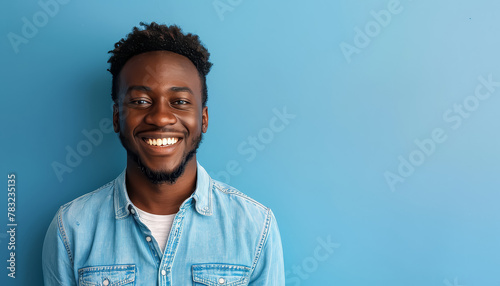 A man with a beard and a blue shirt is smiling photo