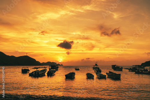 Landscape with beautiful sunset on the sea and boats on the shore. Taganga Beach. Santa Marta, Colombia. 