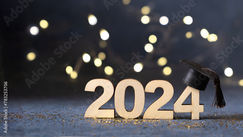 Class of 2024 concept. Number 2024 with graduated cap and bokeh lights banner. photo